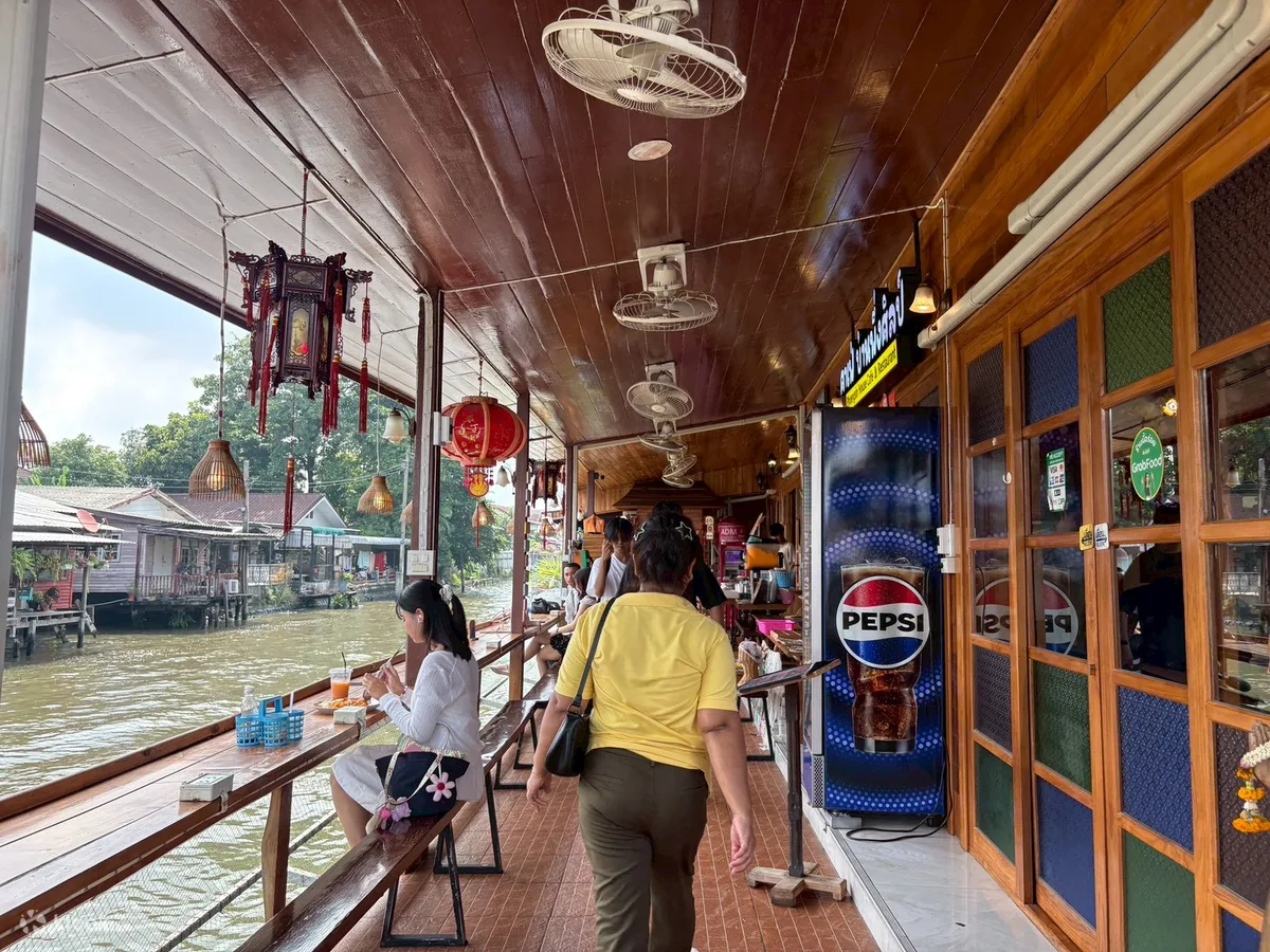 A canalside walkway of shops and cafes in Bangkok