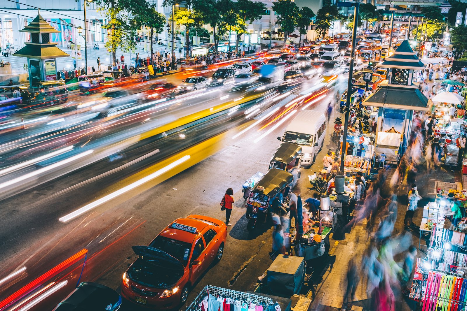 A busy Bangkok night market lit up after dark