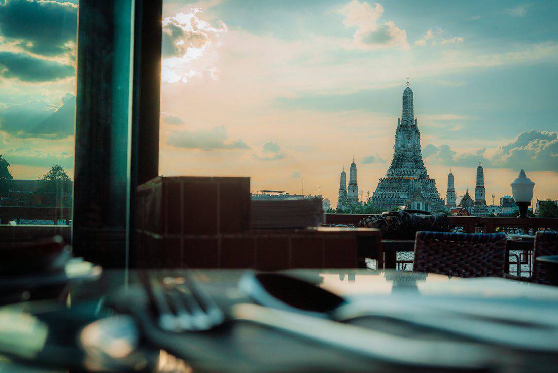 Temple spire against a cloudy sunset sky.