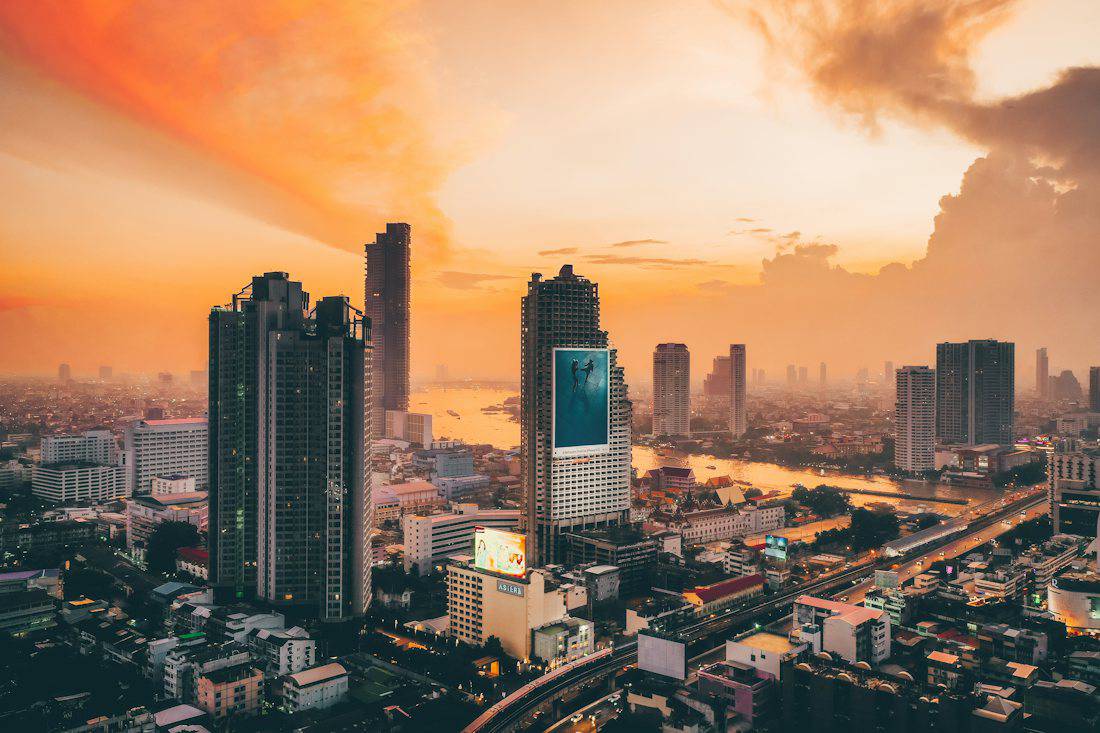 Sunset behind towers along the Chao Phraya River in Bangkok