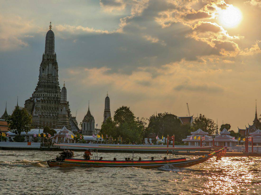 Wat Arun and the Chao Phraya River at sunset
