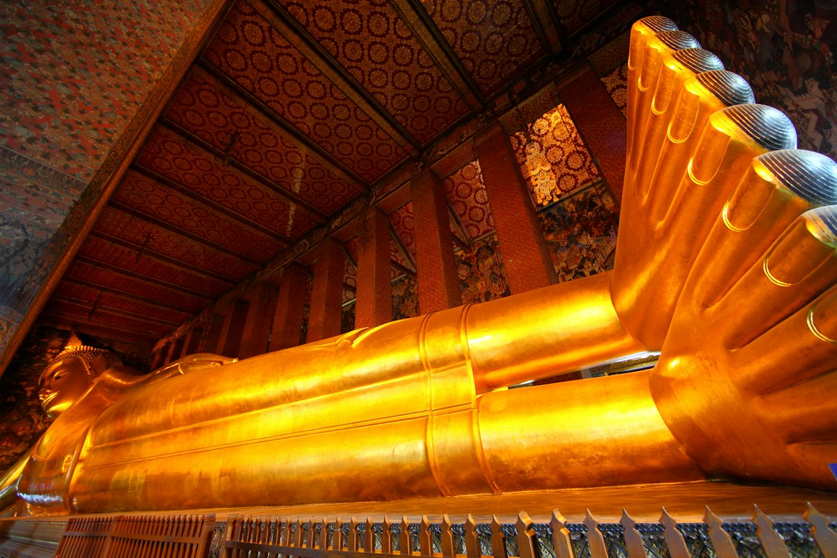 The gold Reclining Buddha stretched along its hall at Wat Pho