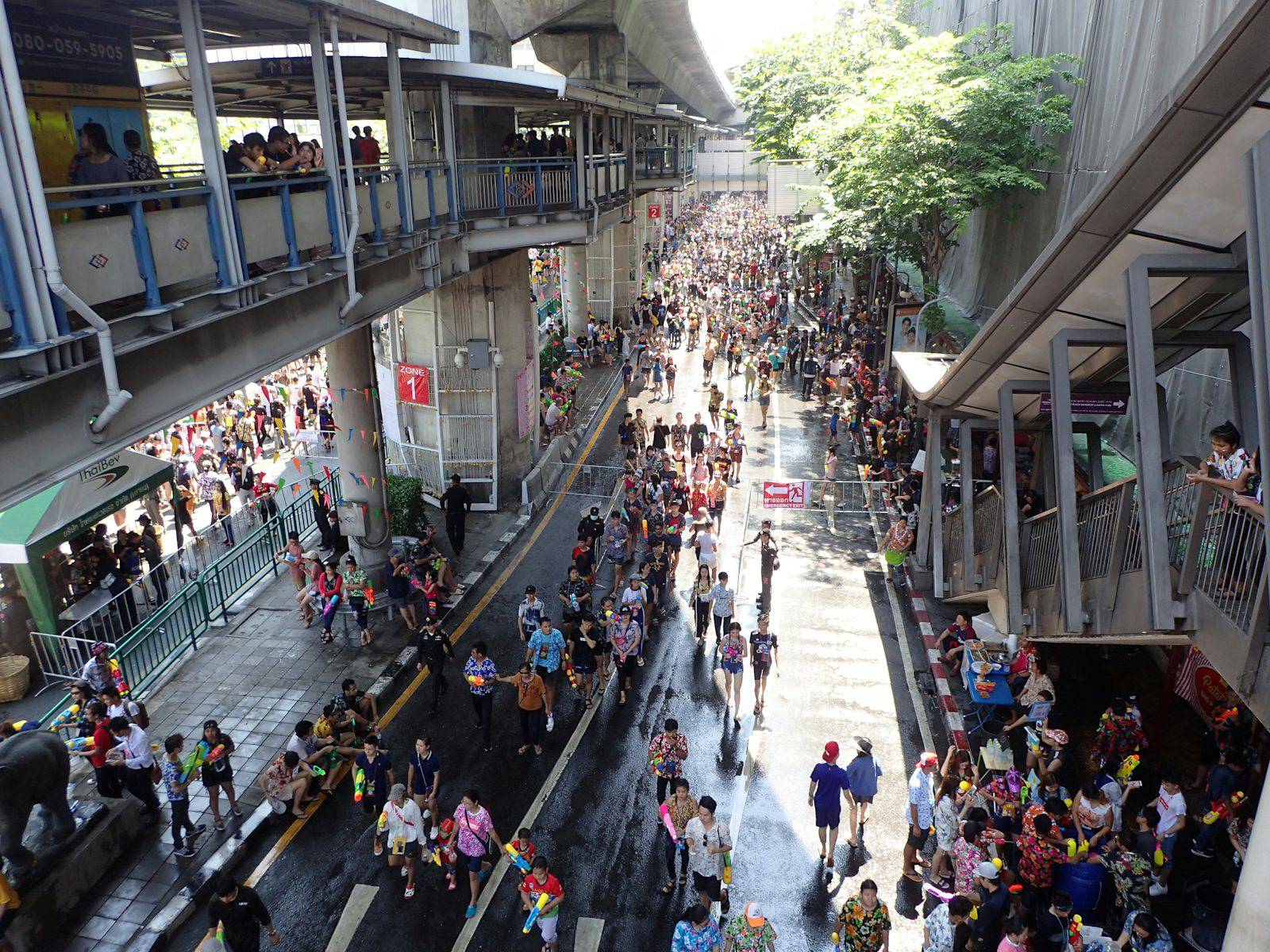Crowds celebrating Songkran with water fights on Silom Road in Bangkok