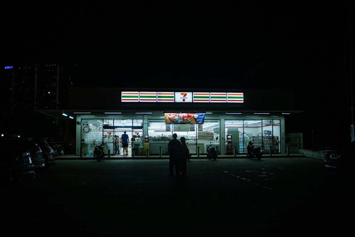 A 7-Eleven store lit up at night in Pattaya, Thailand