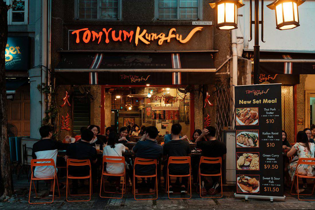 Diners at an open-air Thai restaurant in Bangkok at night