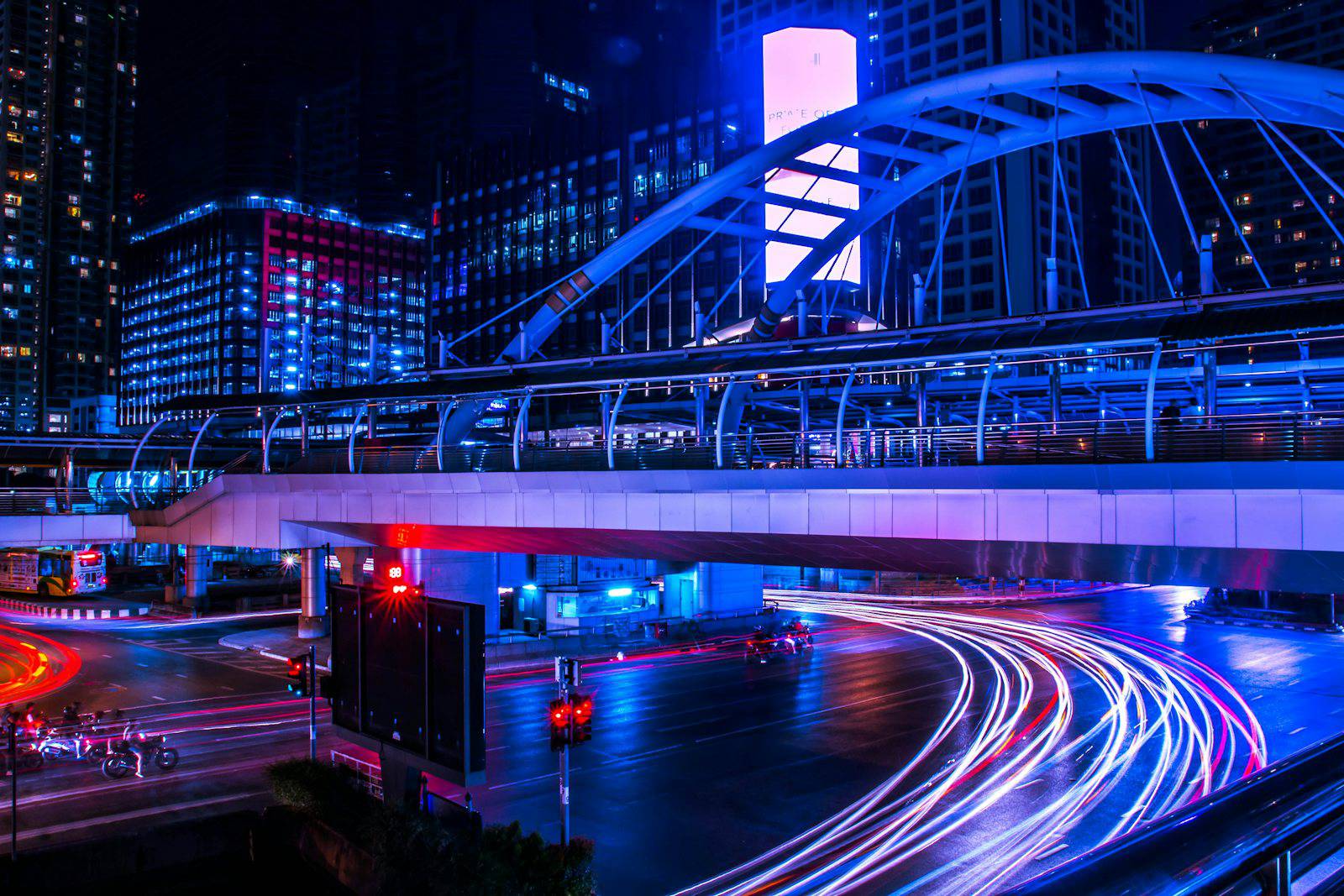 Chong Nonsi skywalk and traffic light trails in Silom Sathorn at night