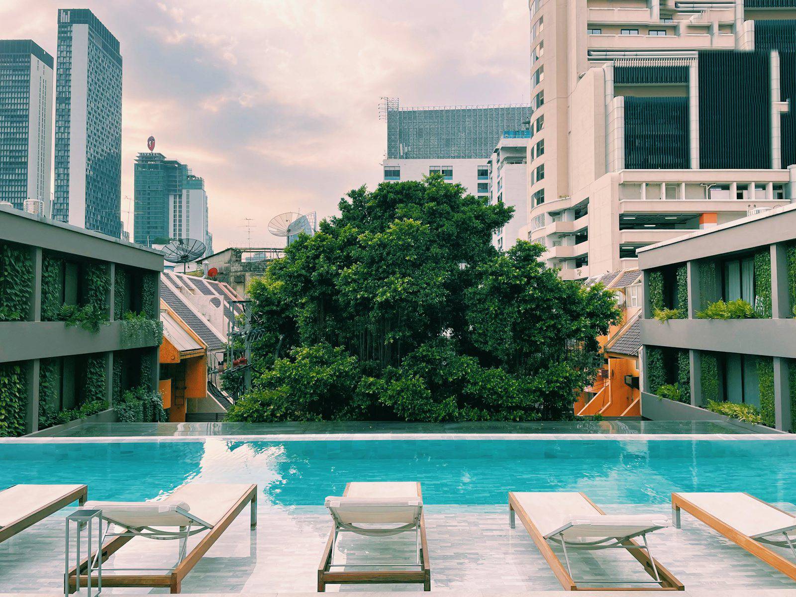 Bangkok hotel pool terrace surrounded by city towers