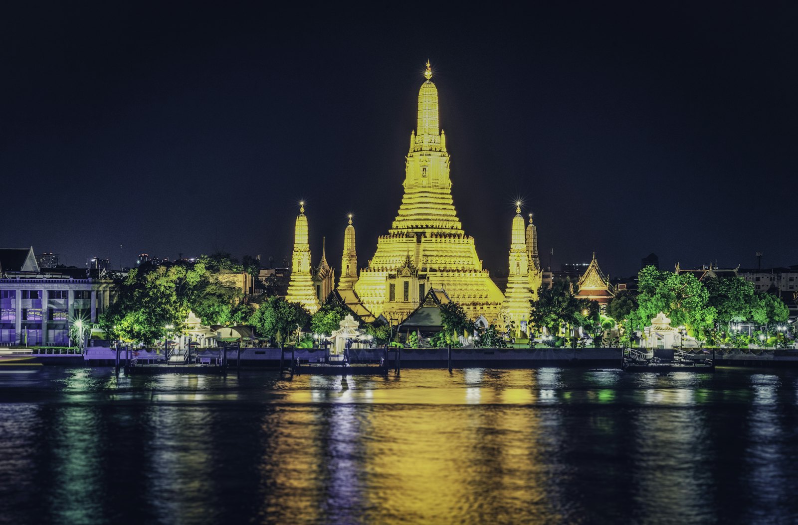 Wat Arun lit up at night on the Chao Phraya river