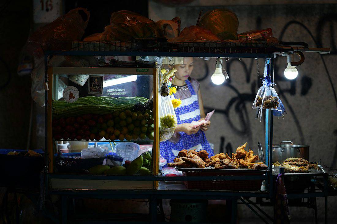 Bangkok street food stall lit up at night