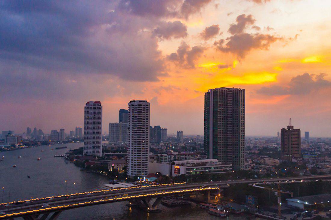 Sunset over the Chao Phraya River and Bangkok towers